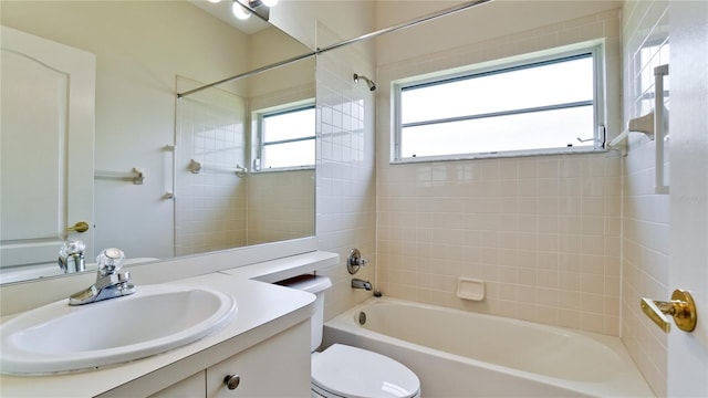 full bathroom featuring vanity, toilet, and tiled shower / bath combo