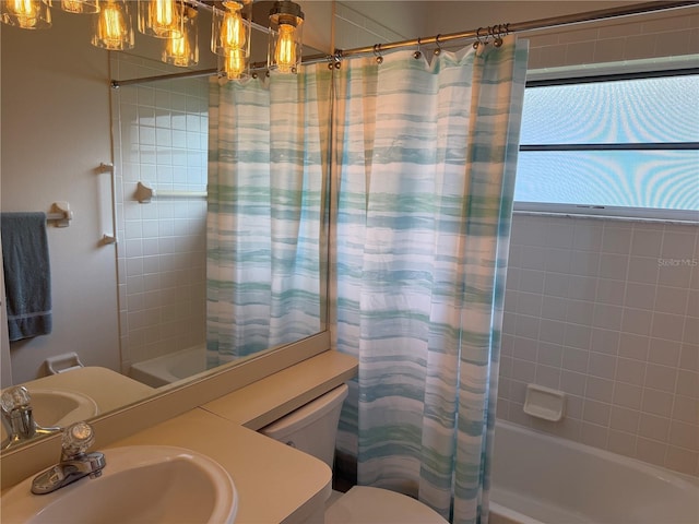 full bathroom with vanity, shower / bath combination with curtain, and toilet