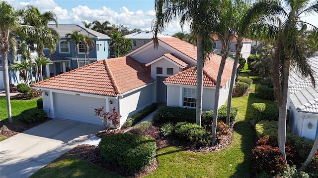 view of front of home featuring a garage and a front yard