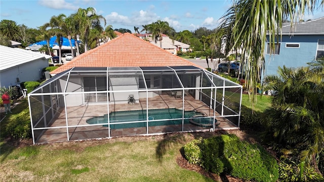 back of property with a patio area and glass enclosure