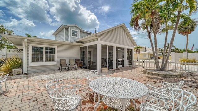 back of house with a patio area and a sunroom