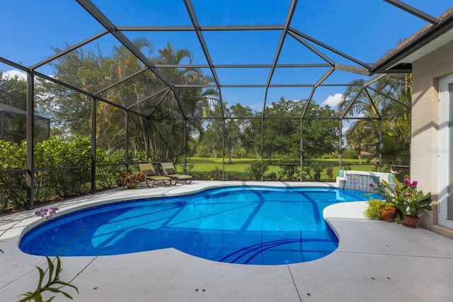 view of swimming pool with glass enclosure and a patio