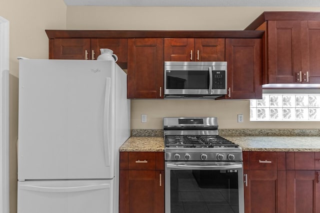 kitchen with stainless steel appliances and light stone countertops