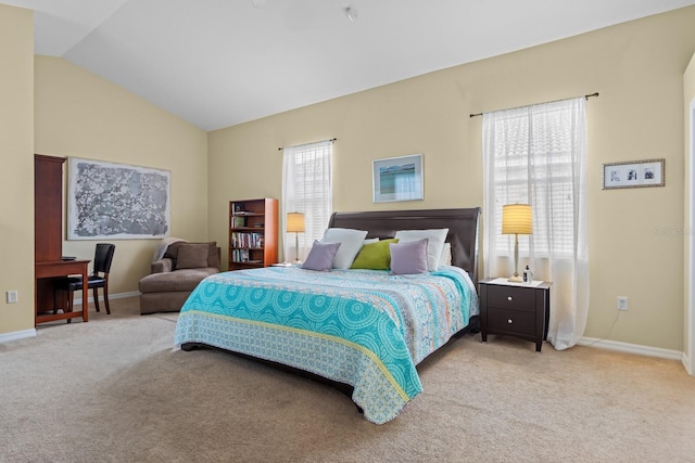 bedroom with light carpet, lofted ceiling, and baseboards