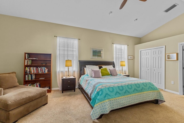 bedroom with lofted ceiling, light carpet, a ceiling fan, visible vents, and baseboards