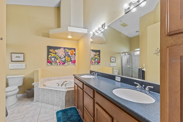 bathroom featuring a garden tub, tile patterned flooring, a sink, and toilet