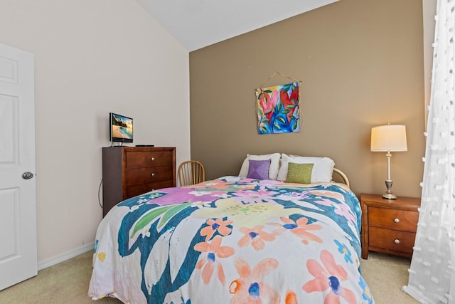 bedroom featuring light carpet, baseboards, and vaulted ceiling