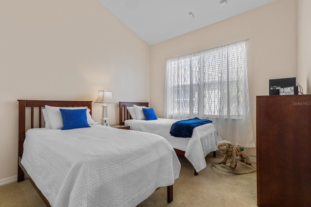 bedroom featuring lofted ceiling, baseboards, and light colored carpet