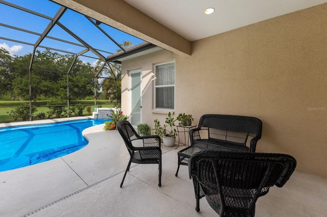 outdoor pool with a patio area, glass enclosure, and outdoor lounge area