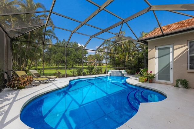 outdoor pool with a lanai and a patio area