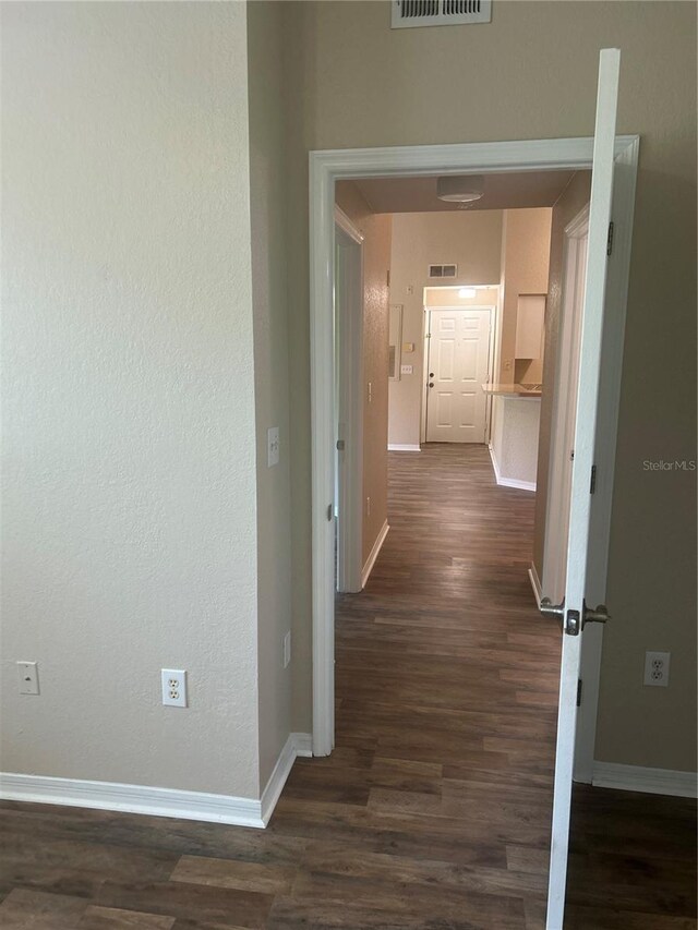 corridor with dark hardwood / wood-style floors