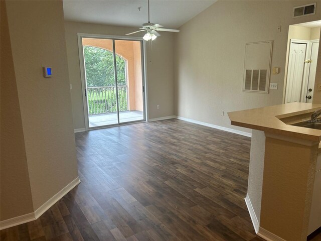 interior space with ceiling fan, vaulted ceiling, dark hardwood / wood-style flooring, and sink