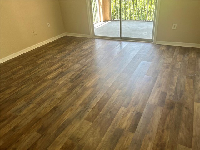 unfurnished room with dark hardwood / wood-style floors