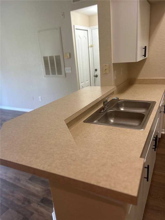 kitchen featuring white cabinets, sink, and dark hardwood / wood-style floors