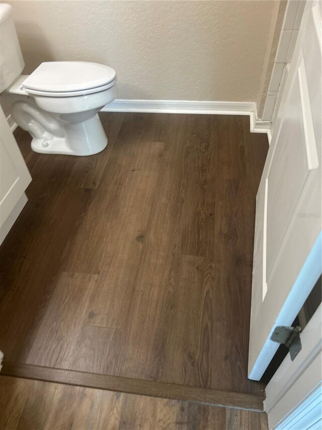 bathroom featuring toilet and hardwood / wood-style floors