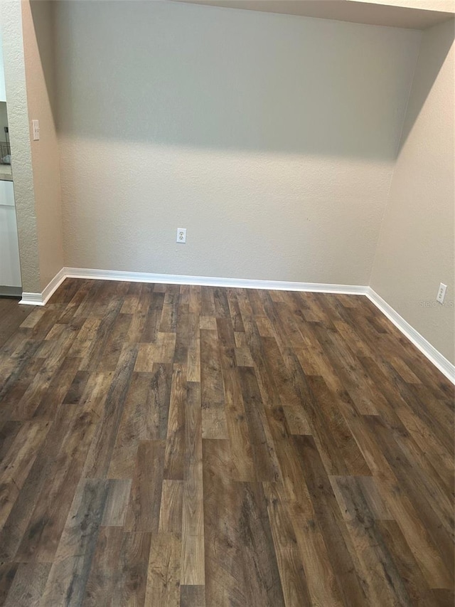 empty room with dark hardwood / wood-style floors