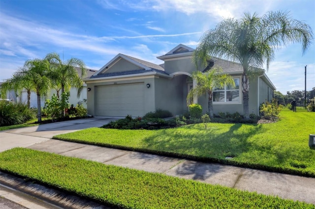 view of front facade featuring a garage and a front lawn