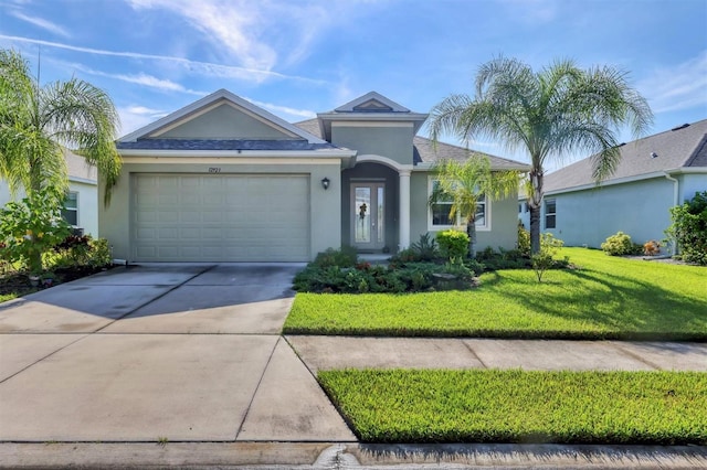 ranch-style house featuring a garage and a front lawn