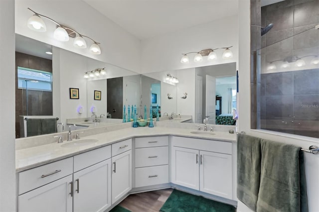 bathroom with hardwood / wood-style flooring and dual bowl vanity