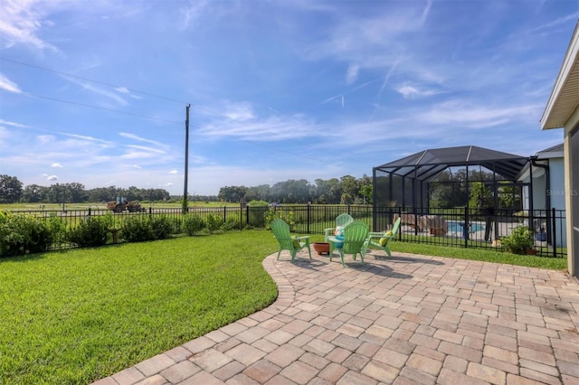 view of yard featuring a patio, a swimming pool, and glass enclosure