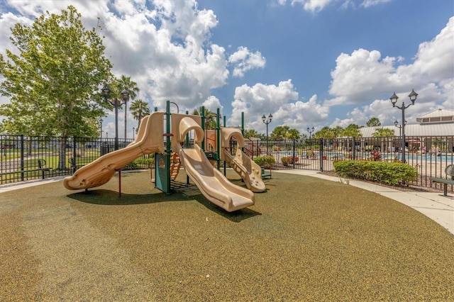 view of playground featuring a pool