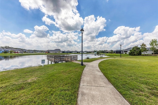 exterior space with a water view and a lawn