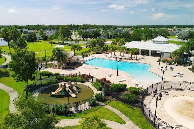 view of swimming pool with a patio area, a playground, and a yard