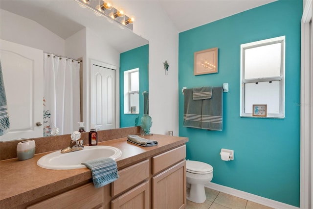 bathroom featuring tile patterned floors, vanity, lofted ceiling, and toilet