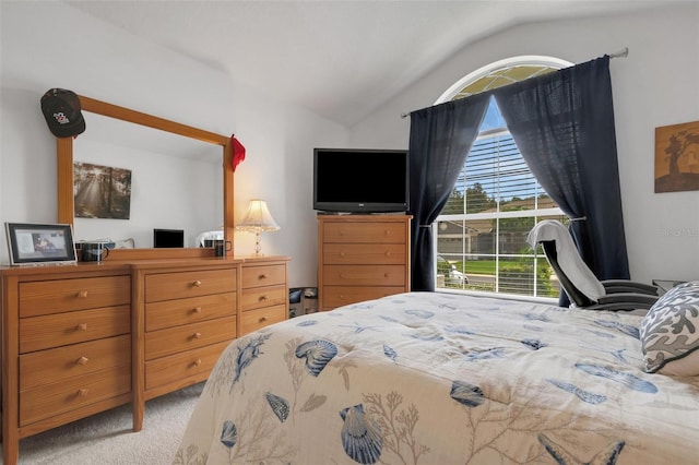 bedroom with light colored carpet and vaulted ceiling