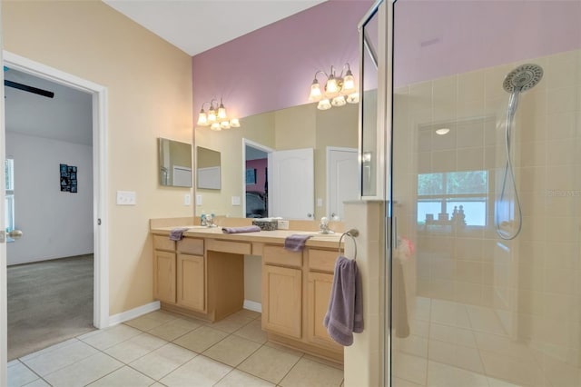 bathroom with a shower with shower door, vanity, tile patterned floors, and an inviting chandelier