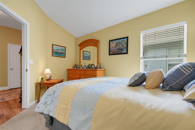 bedroom featuring lofted ceiling and hardwood / wood-style flooring