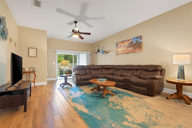 living room featuring ceiling fan and light wood-type flooring