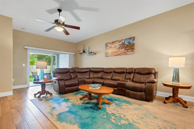 living room with ceiling fan and light hardwood / wood-style flooring