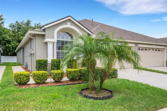 ranch-style home with a front yard and a garage