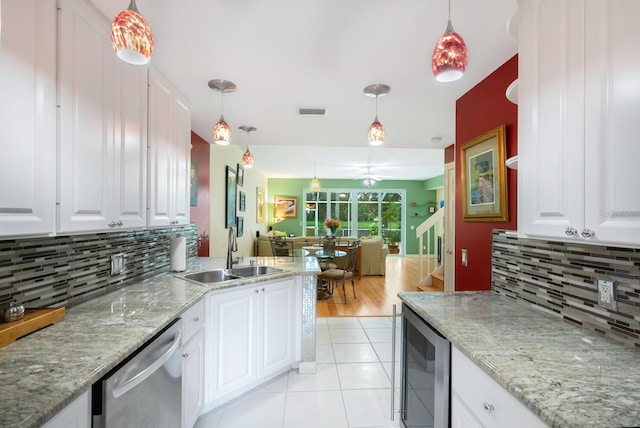 kitchen featuring beverage cooler, dishwasher, backsplash, light hardwood / wood-style floors, and white cabinetry