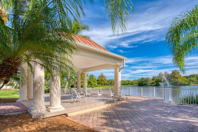 exterior space with a water view and a patio area