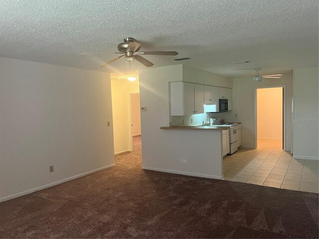 kitchen with white range with electric stovetop, kitchen peninsula, white cabinets, and light colored carpet