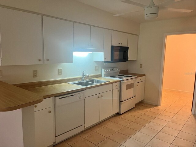 kitchen featuring ceiling fan, sink, light tile patterned flooring, white appliances, and white cabinets