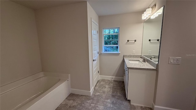 bathroom featuring vanity and a washtub