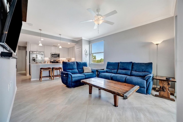 tiled living room featuring sink, crown molding, and ceiling fan