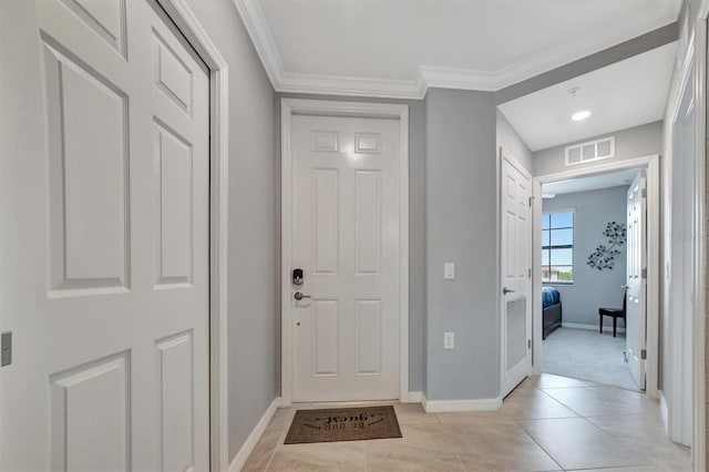 tiled foyer entrance featuring ornamental molding