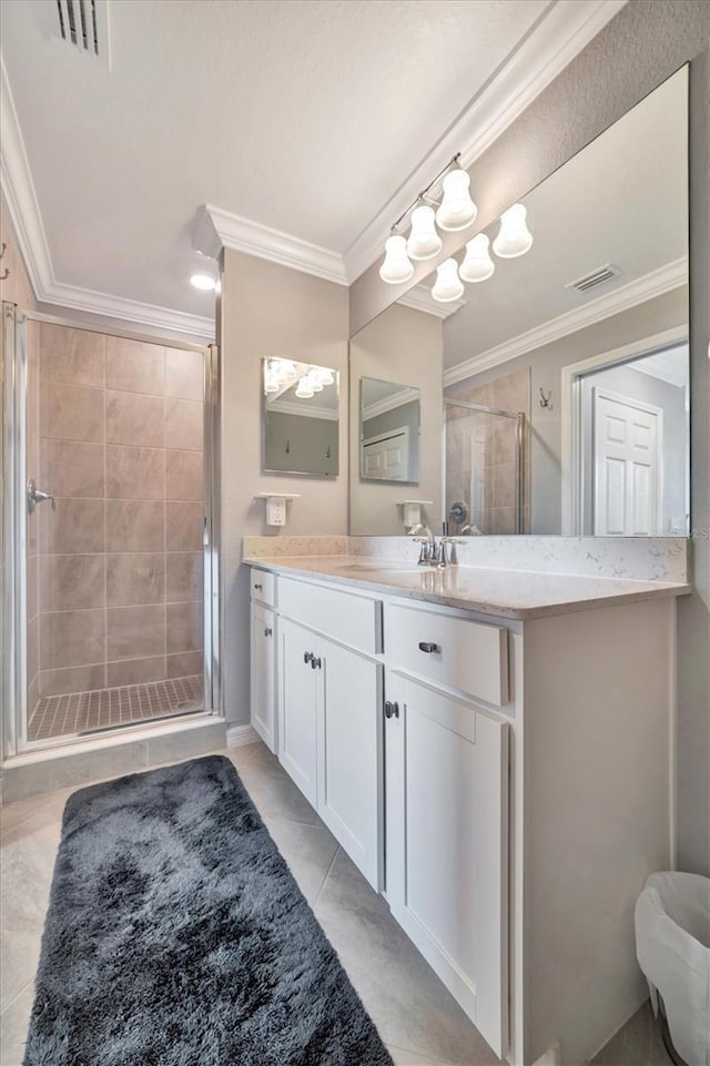 bathroom with vanity, tile patterned floors, crown molding, and walk in shower