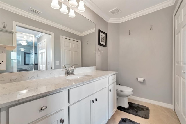 bathroom with tile patterned flooring, vanity, ornamental molding, and toilet