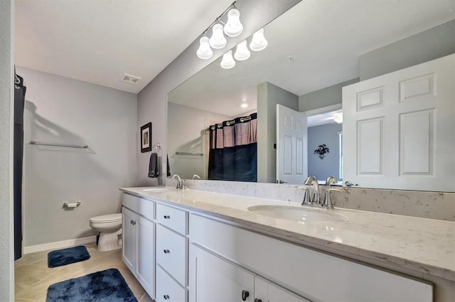 bathroom featuring tile patterned flooring, vanity, curtained shower, and toilet