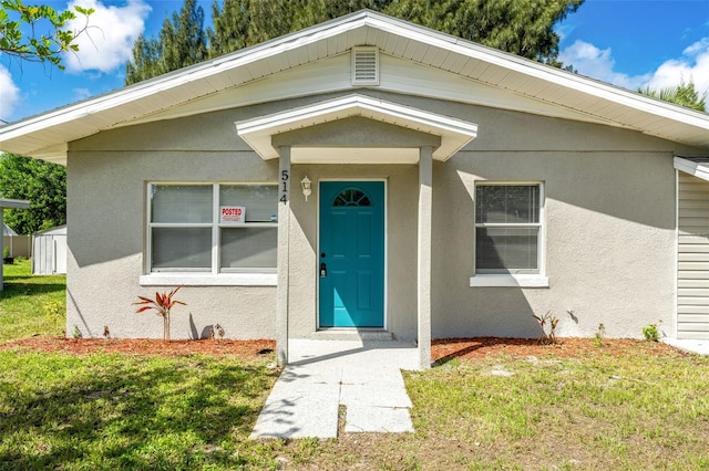 property entrance with a yard