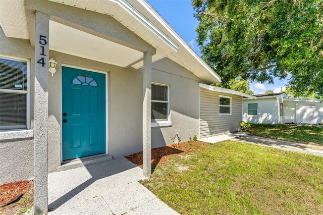 doorway to property with a yard