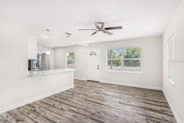 interior space featuring light wood-type flooring and ceiling fan