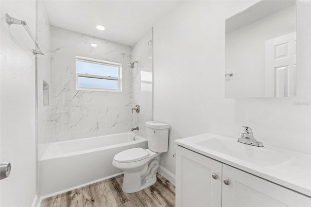 full bathroom with toilet, hardwood / wood-style floors, vanity, and tiled shower / bath