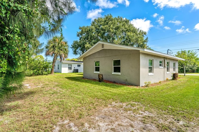 view of home's exterior with a yard