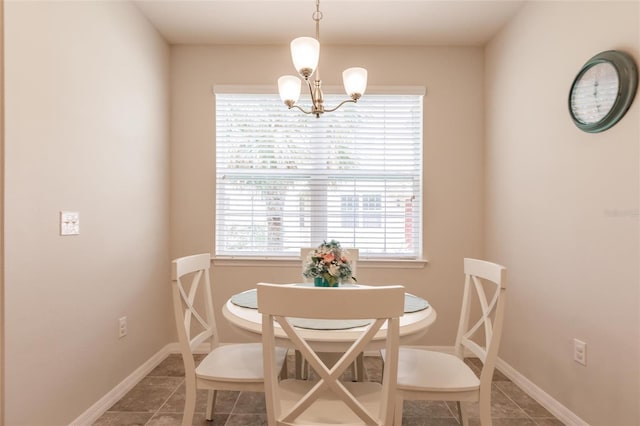 dining area with tile patterned flooring and an inviting chandelier